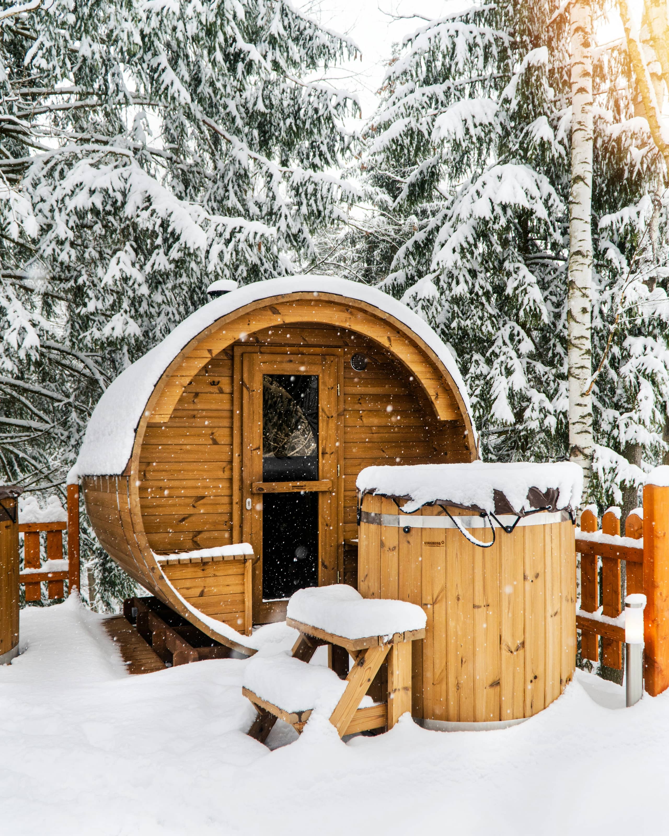 Modern barrel sauna in a snowy landscape